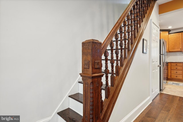 stairway featuring wood-type flooring