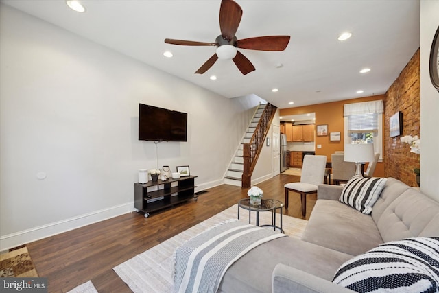 living room featuring wood-type flooring and ceiling fan