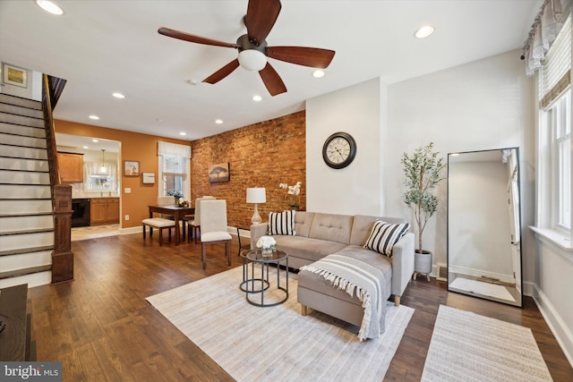 living room featuring ceiling fan and dark hardwood / wood-style flooring