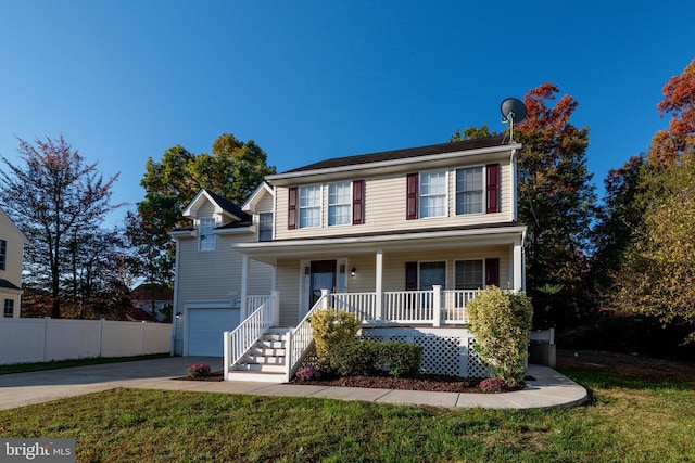 view of front of property with a porch, a front yard, and a garage