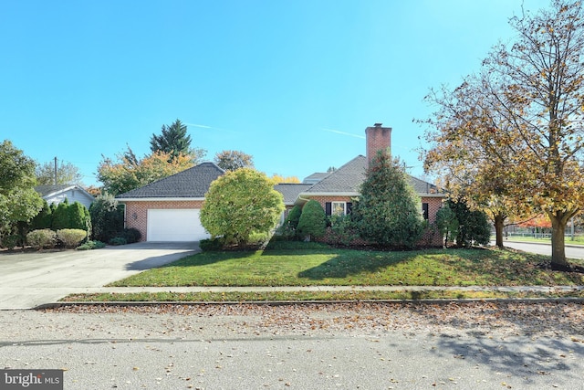 view of front of property with a front lawn and a garage