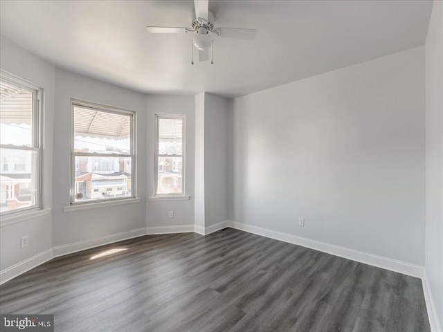 unfurnished room featuring dark hardwood / wood-style floors and ceiling fan