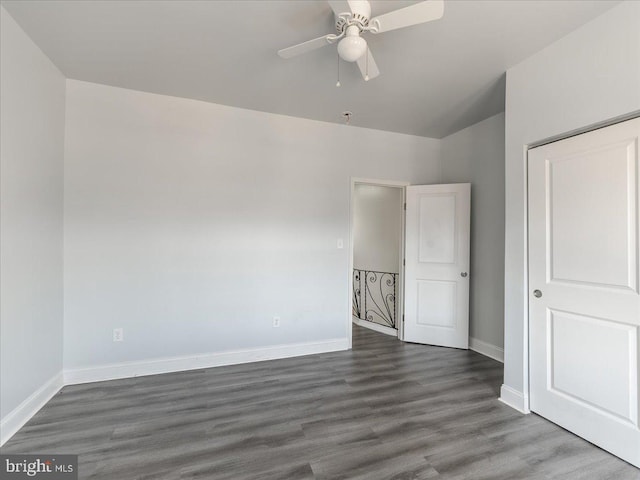 unfurnished bedroom with dark hardwood / wood-style floors and ceiling fan