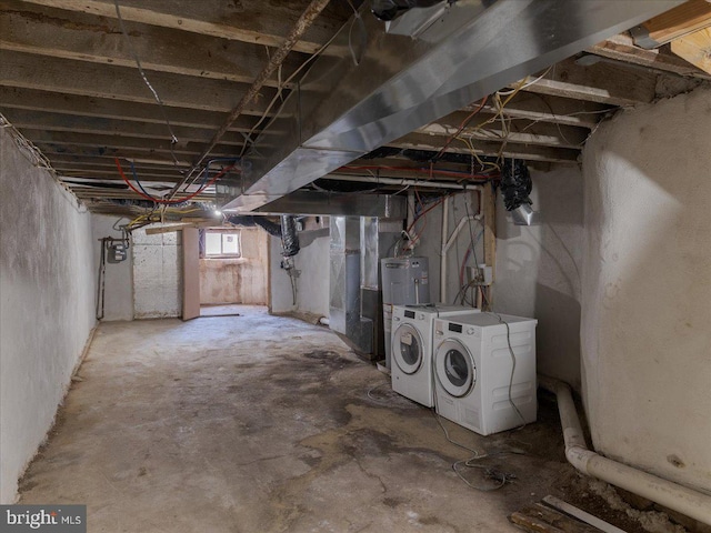 basement with washer and dryer and electric water heater