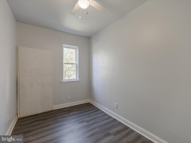 empty room with dark wood-type flooring and ceiling fan