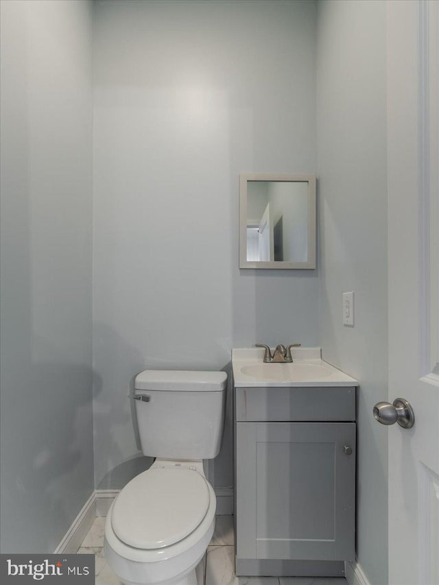 bathroom with vanity, toilet, and tile patterned floors