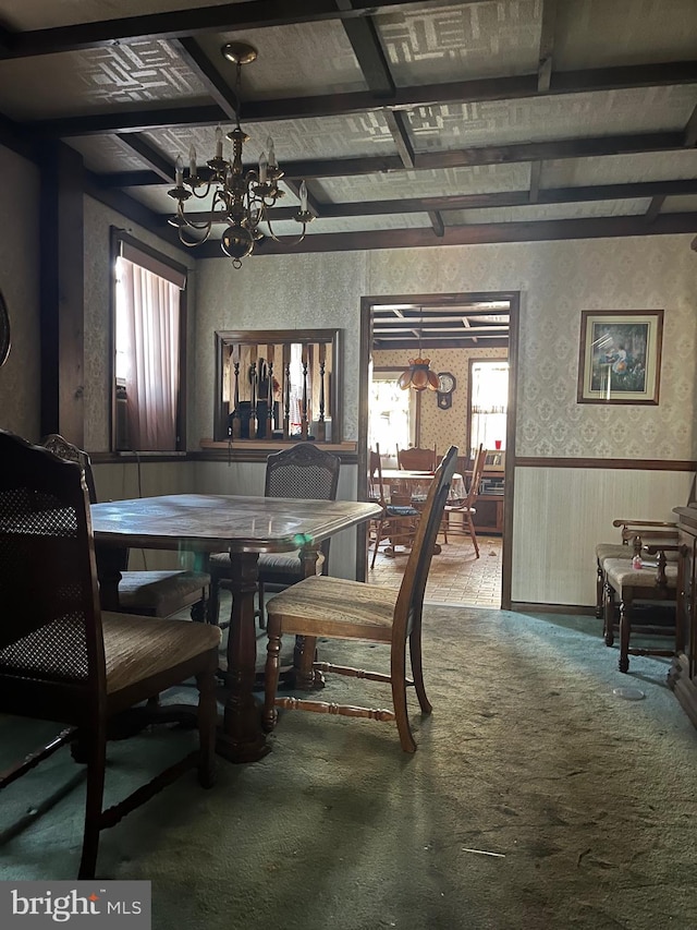 dining space featuring an inviting chandelier, carpet, beam ceiling, and plenty of natural light