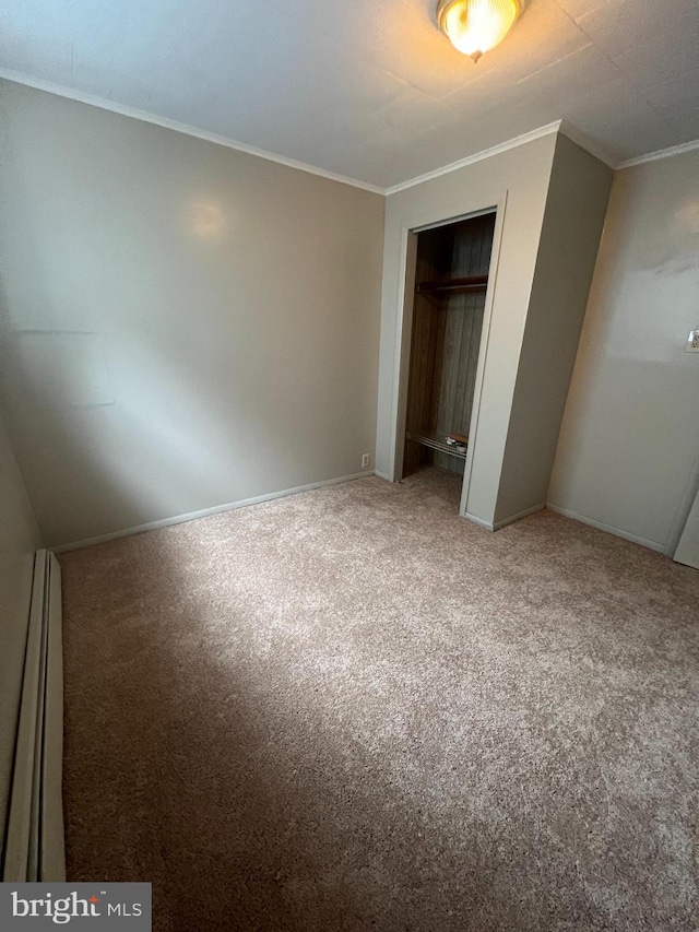 unfurnished bedroom with ornamental molding, carpet, and a closet