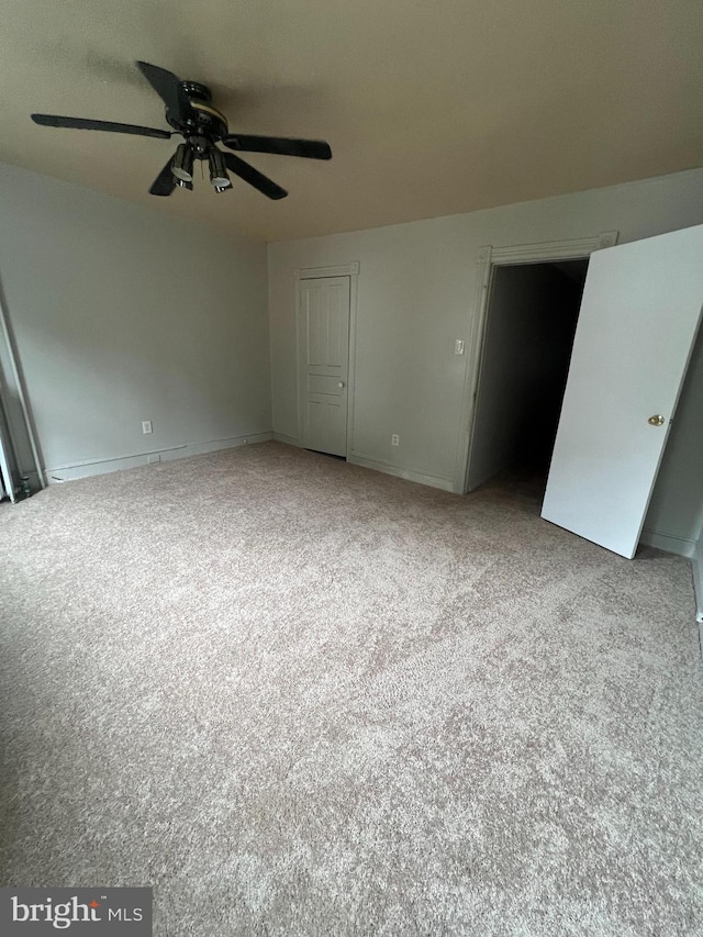 unfurnished bedroom featuring light colored carpet, a closet, and ceiling fan