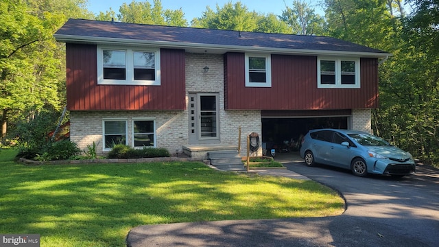 bi-level home with a garage and a front yard