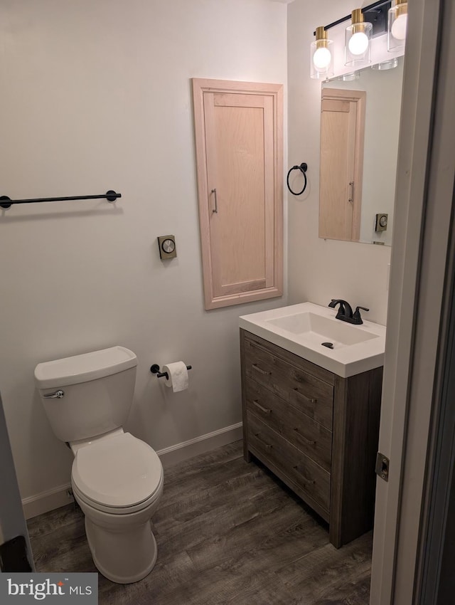 bathroom featuring hardwood / wood-style floors, vanity, and toilet