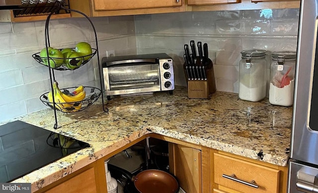 31 S Jersey Ave, Dorothy, NJ 08317 - kitchen with black electric stovetop, brown cabinets, a toaster, and backsplash
