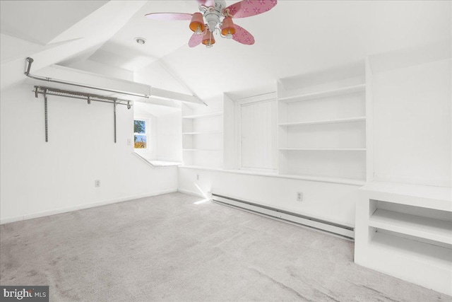 walk in closet featuring lofted ceiling, a baseboard heating unit, light colored carpet, and ceiling fan