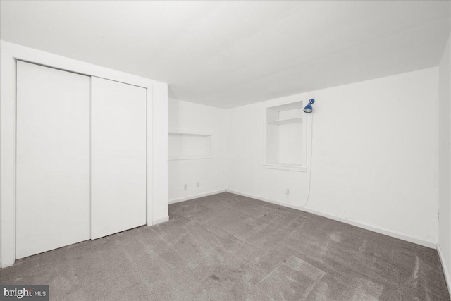 unfurnished bedroom with a closet and carpet