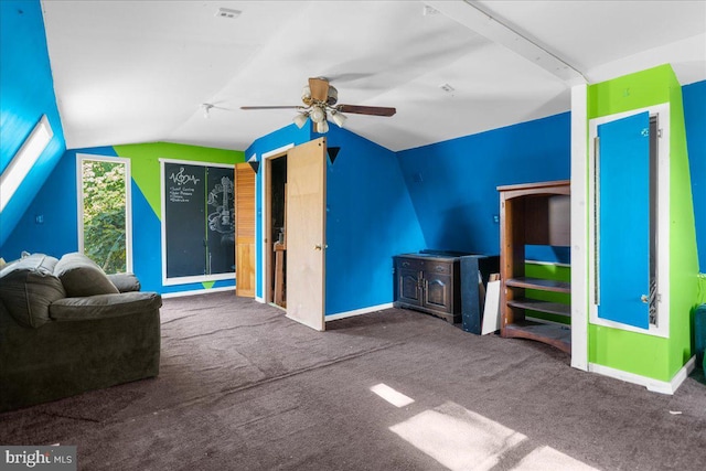 interior space with lofted ceiling with beams, carpet flooring, and ceiling fan