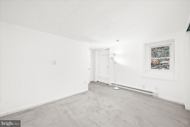 carpeted spare room with a baseboard radiator