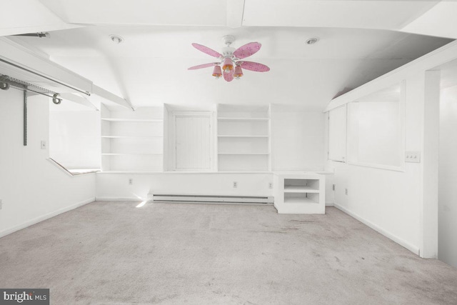 spacious closet featuring ceiling fan, lofted ceiling, a baseboard heating unit, and light colored carpet