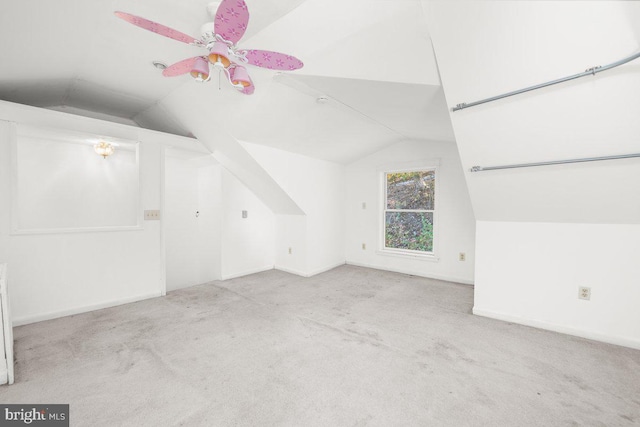 bonus room featuring vaulted ceiling, light carpet, and ceiling fan