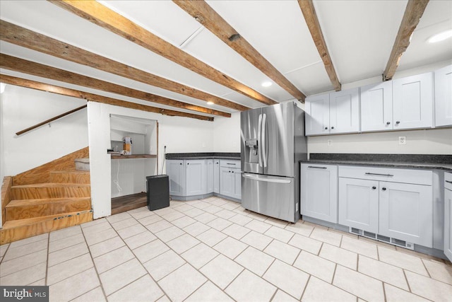 kitchen with white cabinetry, beamed ceiling, and stainless steel fridge with ice dispenser