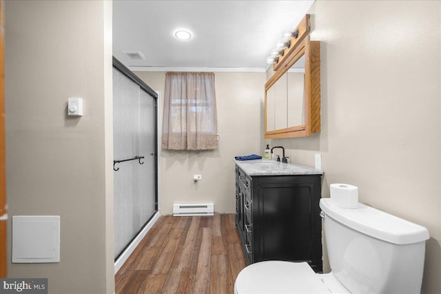 bathroom with a shower with door, wood-type flooring, toilet, baseboard heating, and vanity