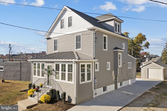 front of property with an outdoor structure and a garage