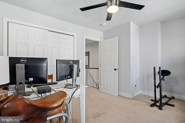 office space featuring light carpet and ceiling fan