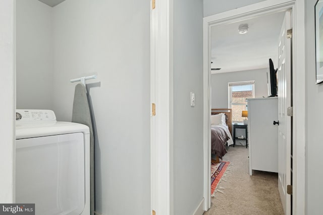 washroom featuring light carpet and washer / clothes dryer