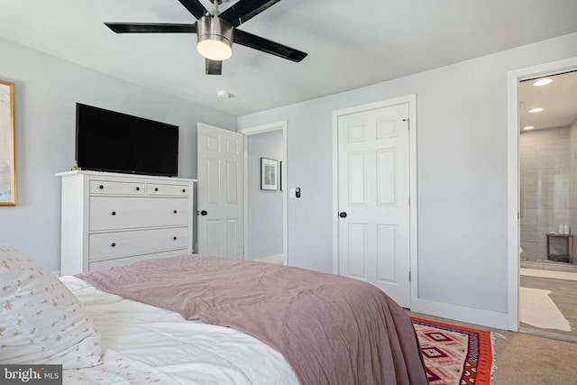 bedroom with ensuite bath and ceiling fan