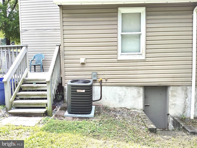 view of home's exterior with cooling unit and a deck