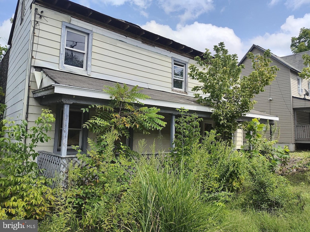 view of property exterior with a shingled roof