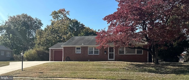 view of front of house with a front yard and a garage