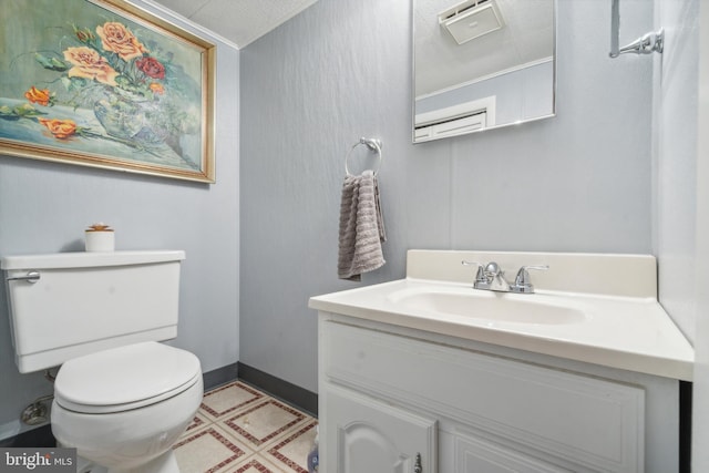 bathroom featuring toilet, a textured ceiling, and vanity