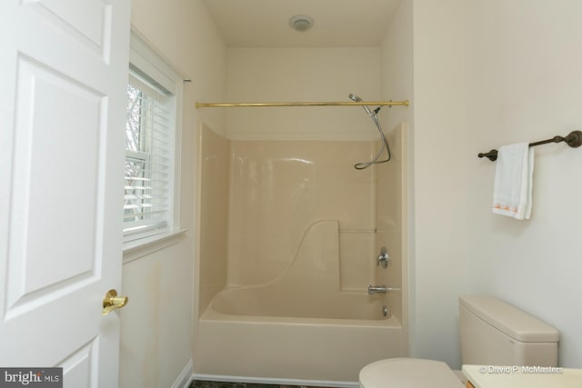 bathroom with toilet and shower / bath combination