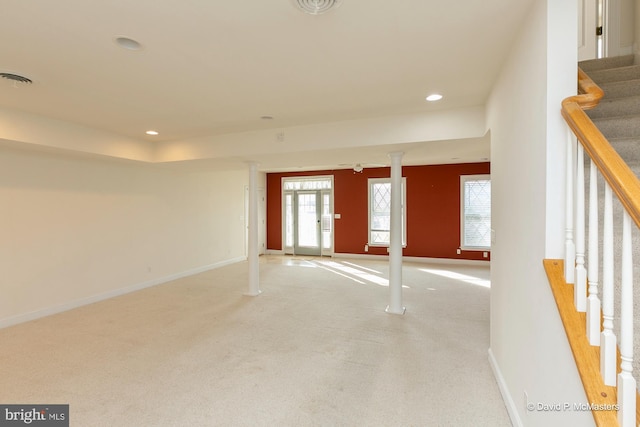 carpeted empty room featuring ornate columns