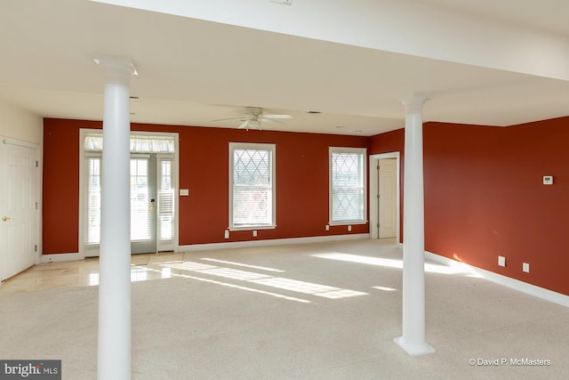 interior space featuring decorative columns and ceiling fan