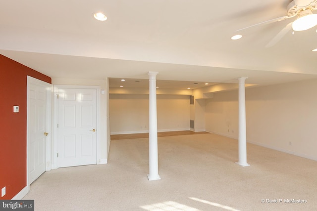 basement featuring ceiling fan and light colored carpet