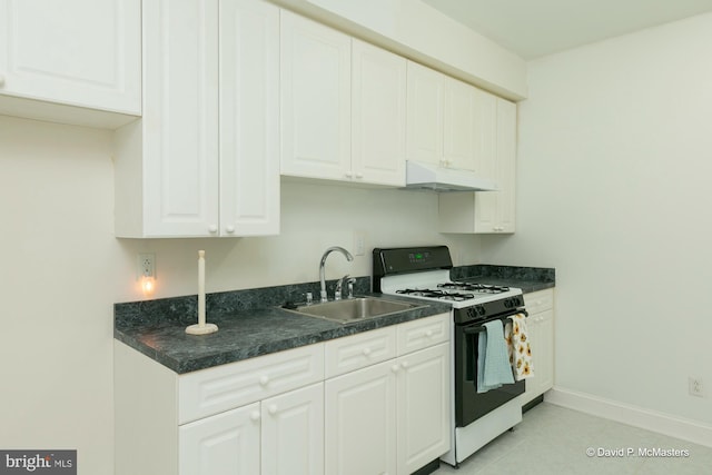 kitchen featuring white cabinetry, sink, light tile patterned floors, and gas range oven