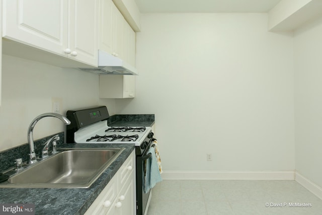 kitchen with gas stove, sink, and white cabinets