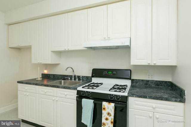 kitchen featuring gas stove, sink, and white cabinets