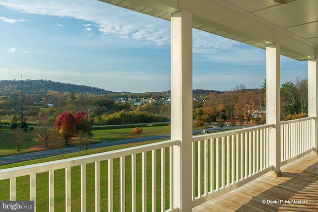 wooden terrace featuring a lawn