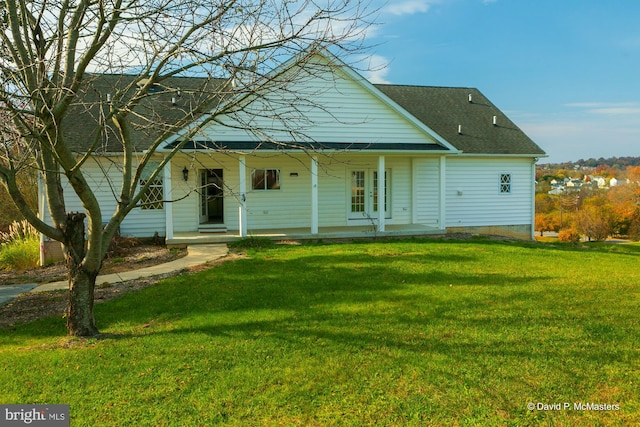 rear view of house with a porch and a lawn