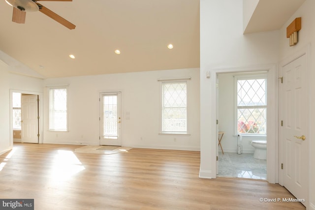 interior space with ceiling fan, plenty of natural light, vaulted ceiling, and light wood-type flooring