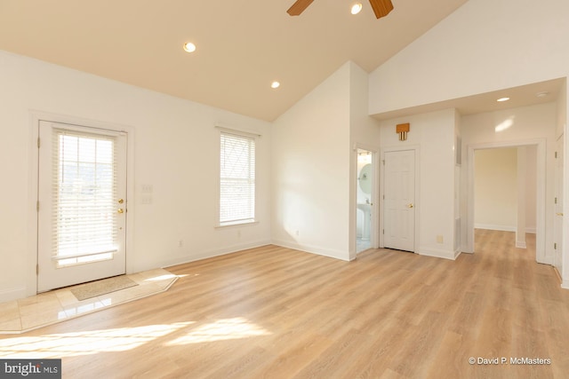 unfurnished living room featuring ceiling fan, high vaulted ceiling, and light hardwood / wood-style floors