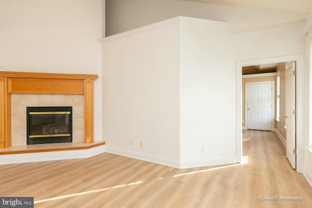 unfurnished living room with a fireplace and light hardwood / wood-style flooring