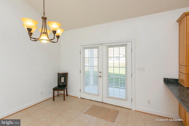 entryway with french doors, lofted ceiling, an inviting chandelier, and light tile patterned floors