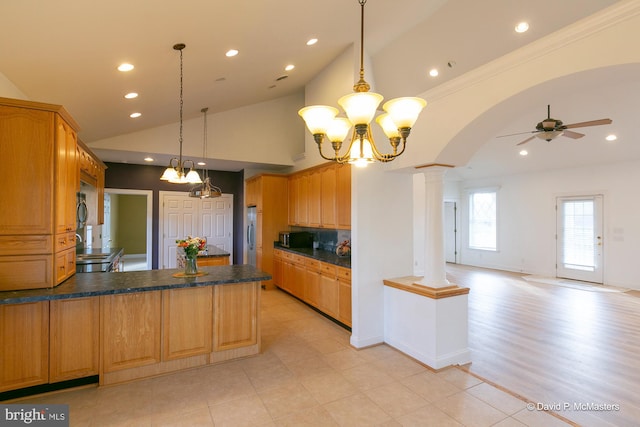 kitchen with ceiling fan with notable chandelier, decorative light fixtures, decorative columns, ornamental molding, and stainless steel appliances