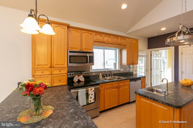 kitchen featuring sink, decorative light fixtures, vaulted ceiling, appliances with stainless steel finishes, and decorative backsplash