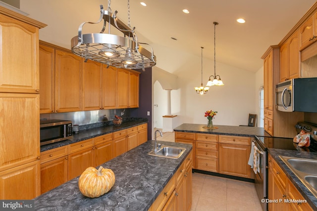 kitchen with lofted ceiling, sink, appliances with stainless steel finishes, hanging light fixtures, and light tile patterned flooring