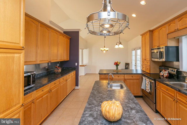 kitchen featuring stainless steel appliances, lofted ceiling, sink, and pendant lighting