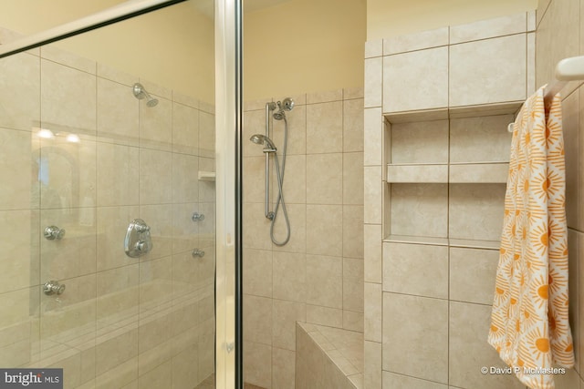 bathroom featuring a shower with door